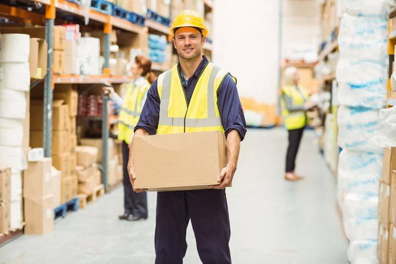 Man carrying a box in a warehouse
