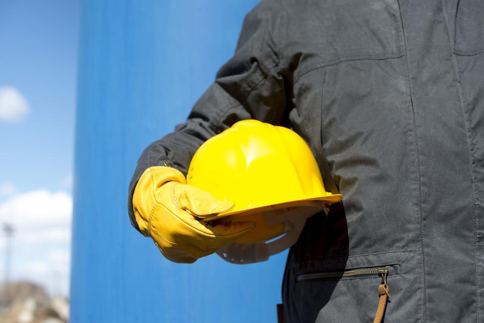 man with yellow hardhat and gloves